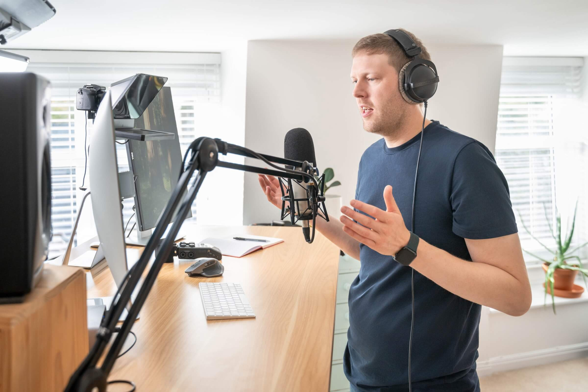 Rory talking to a client at his desk about why Not to start a podcast