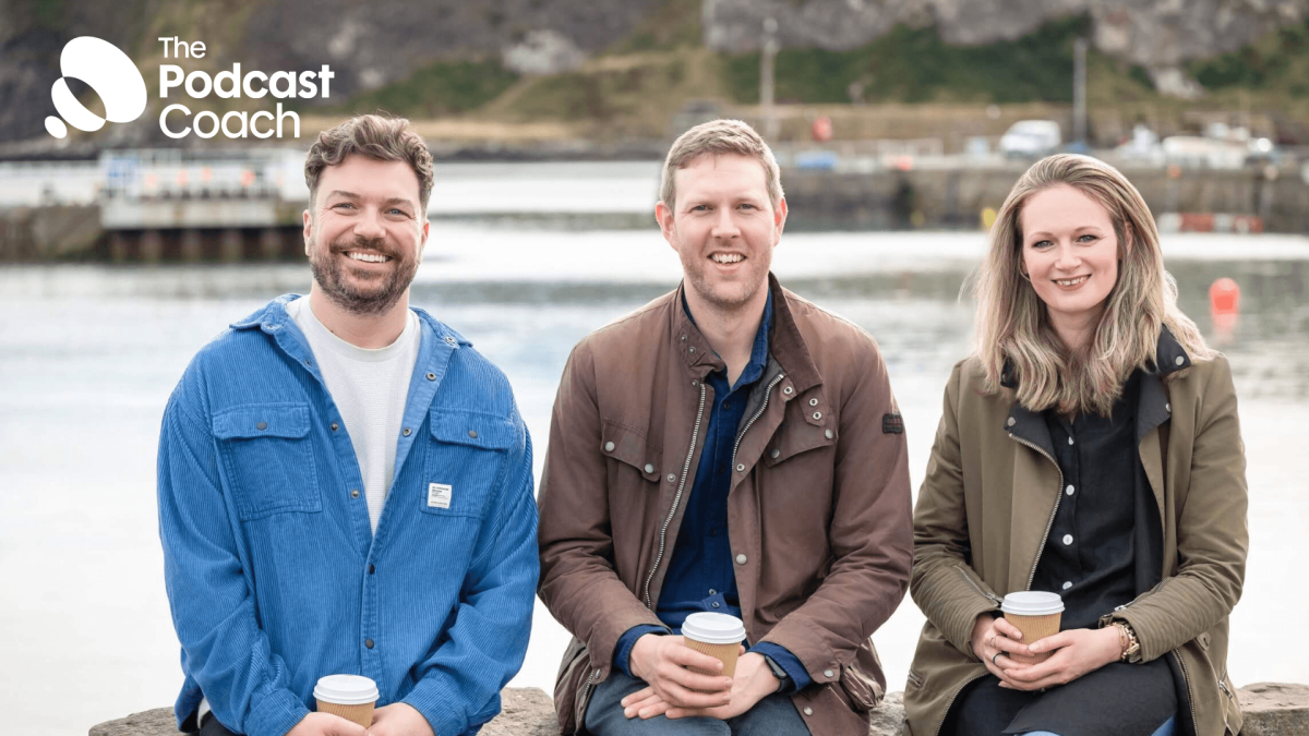Ben, Rory and Lizi - the Podcast Coach directors - sit on a wall looking at the camera.
